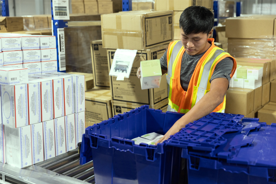 Workers packaging healthcare solutions