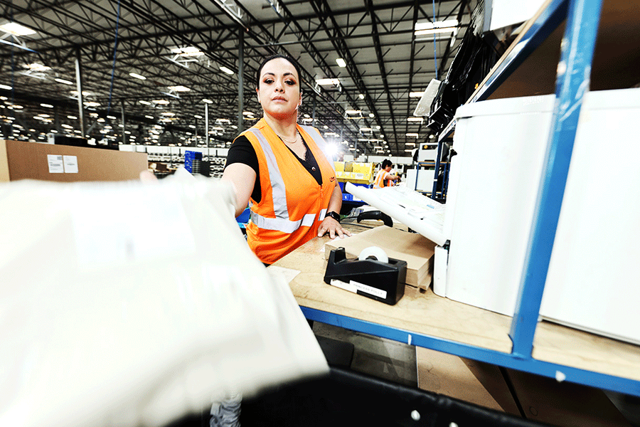 fulfillment center employee handing off package