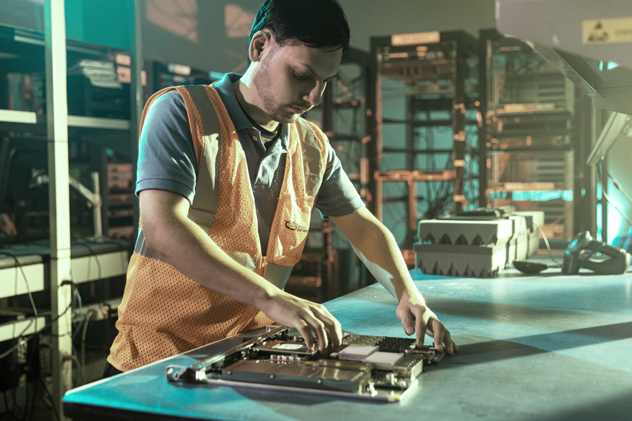 An employee performing quality assurance on a product before shipping it to the customer