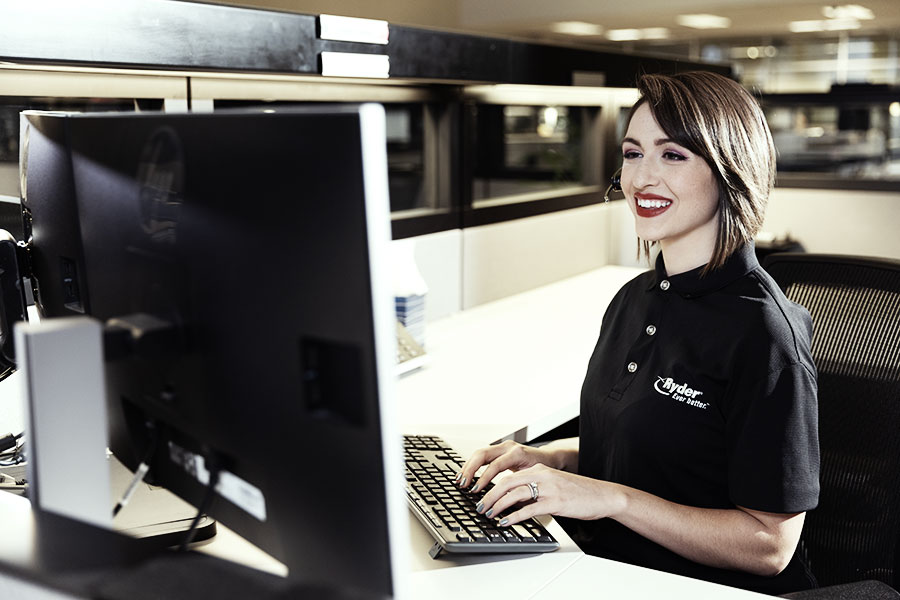 ladie sitting at a desk typing on a keyboard